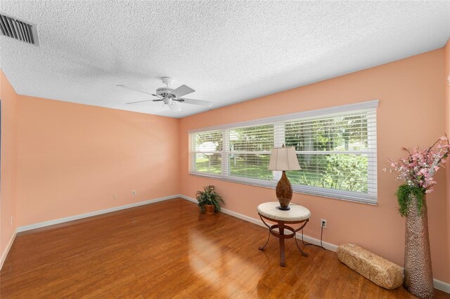9085 SW 96th Ln Unit B, Ocala, FL 34481 - spare room with wood finished floors, ceiling fan, and a textured ceiling