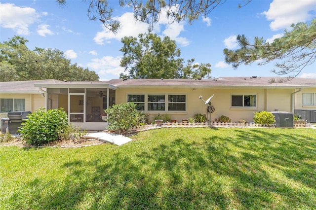 9085 SW 96th Ln Unit B, Ocala, FL 34481 - back of property with a sunroom, a lawn, and a ceiling fan