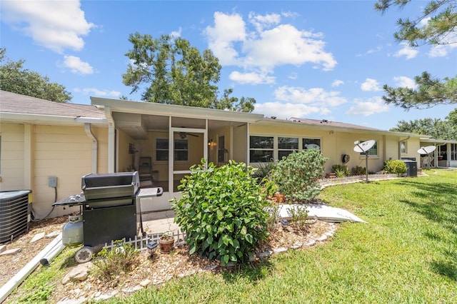 9085 SW 96th Ln Unit B, Ocala, FL 34481 - rear view of house featuring a sunroom and a lawn