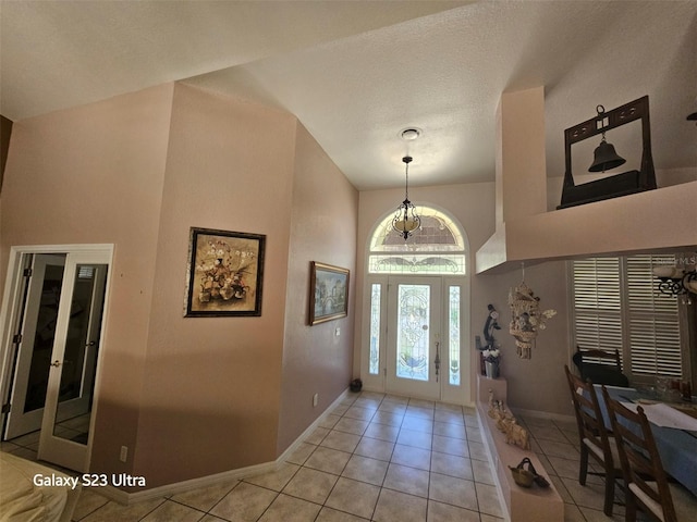 5408 W Corral Pl, Beverly Hills, FL 34465 - entryway featuring a towering ceiling, light tile patterned flooring, and a chandelier
