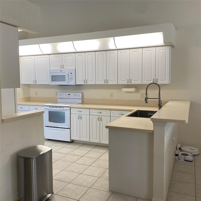 9923 SE 64th Ave, Belleview, FL 34420 - kitchen with white appliances, light tile patterned floors, a peninsula, white cabinets, and light countertops
