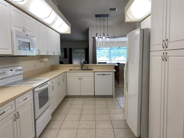 9923 SE 64th Ave, Belleview, FL 34420 - kitchen featuring white appliances, light tile patterned flooring, white cabinets, and light countertops