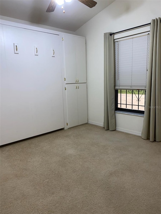 9923 SE 64th Ave, Belleview, FL 34420 - unfurnished bedroom with light carpet, ceiling fan, and vaulted ceiling
