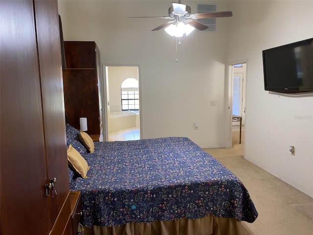 9923 SE 64th Ave, Belleview, FL 34420 - carpeted bedroom featuring a towering ceiling, connected bathroom, and a ceiling fan