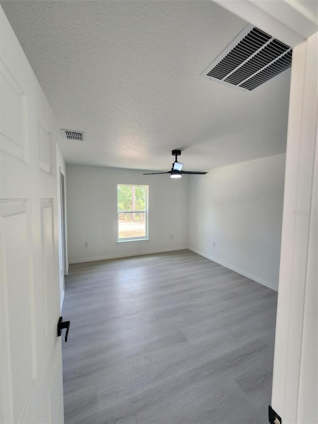 1780 Winding Hills Rd, Dunnellon, FL 34431 - empty room with wood finished floors, ceiling fan, and a textured ceiling
