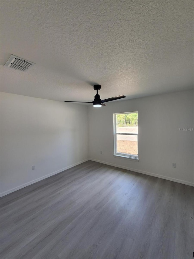 1780 Winding Hills Rd, Dunnellon, FL 34431 - spare room featuring dark wood-type flooring, a ceiling fan, and a textured ceiling
