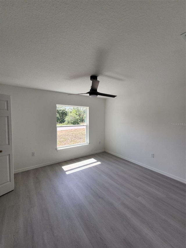 1780 Winding Hills Rd, Dunnellon, FL 34431 - spare room featuring wood finished floors, ceiling fan, and a textured ceiling