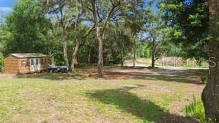 7808 E Savannah Dr, Floral City, FL 34436 - view of green lawn with an outdoor structure