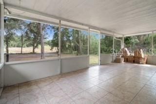 7808 E Savannah Dr, Floral City, FL 34436 - unfurnished sunroom with tile patterned flooring