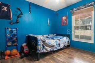 7808 E Savannah Dr, Floral City, FL 34436 - bedroom with wood finished floors and ceiling fan