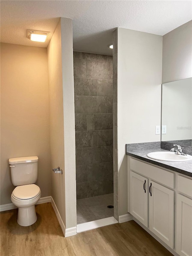 185 Malauka Loop, Ocklawaha, FL 32179 - full bathroom with wood finished floors, vanity, walk in shower, and a textured ceiling