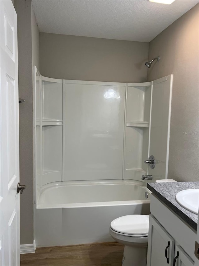 185 Malauka Loop, Ocklawaha, FL 32179 - bathroom with wood finished floors, vanity, a textured ceiling, and tub / shower combination