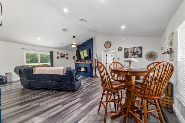 7435 N Nature Trl, Hernando, FL 34442 - dining room featuring lofted ceiling, wood finished floors, a ceiling fan, a glass covered fireplace, and recessed lighting