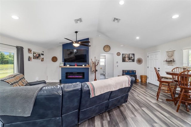 7435 N Nature Trl, Hernando, FL 34442 - living area with vaulted ceiling, a glass covered fireplace, a ceiling fan, wood finished floors, and recessed lighting