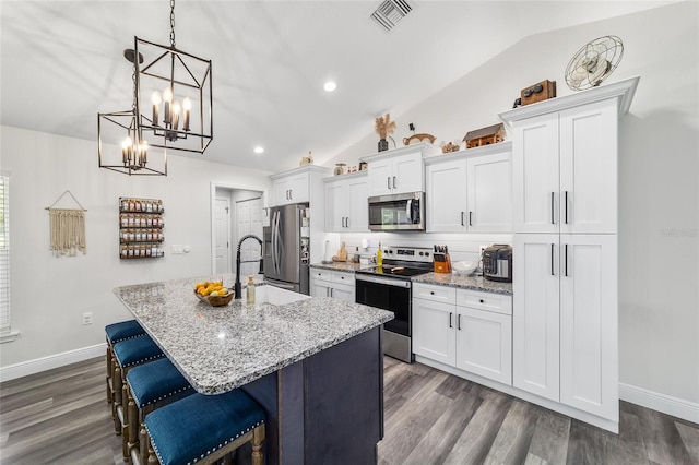 7435 N Nature Trl, Hernando, FL 34442 - kitchen featuring stainless steel appliances, vaulted ceiling, an island with sink, white cabinets, and recessed lighting