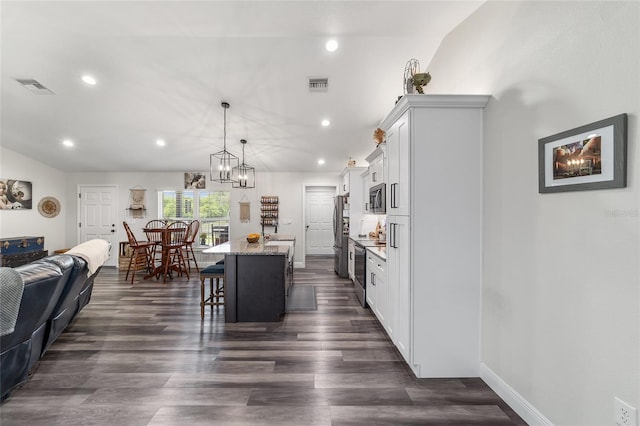 7435 N Nature Trl, Hernando, FL 34442 - kitchen with stainless steel appliances, a breakfast bar area, a center island, white cabinets, and recessed lighting