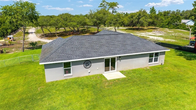 7435 N Nature Trl, Hernando, FL 34442 - back of house featuring stucco siding, view of scattered trees, and roof with shingles