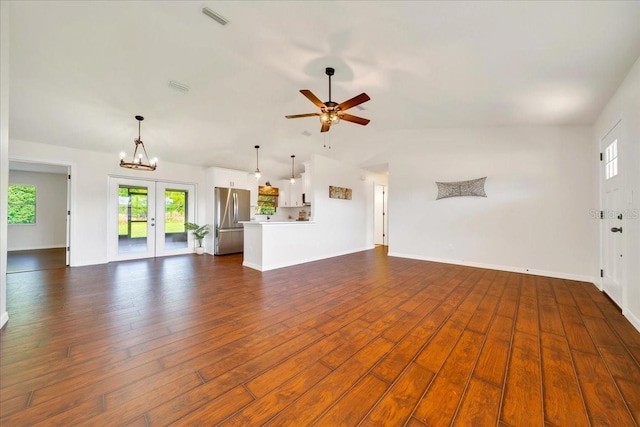 6142 SE 37th Ter, Ocala, FL 34480 - unfurnished living room featuring healthy amount of natural light, french doors, lofted ceiling, a ceiling fan, and dark wood-style flooring