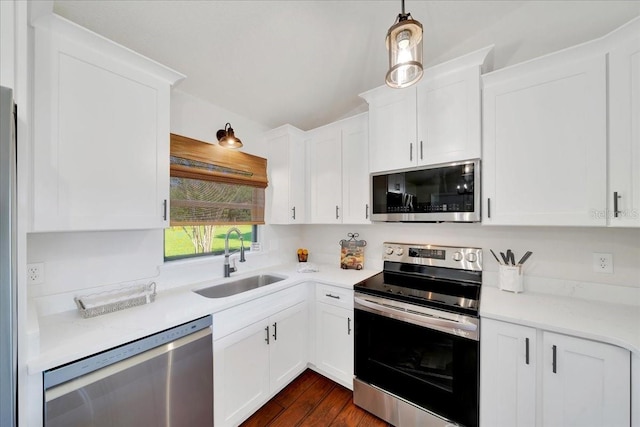6142 SE 37th Ter, Ocala, FL 34480 - kitchen featuring appliances with stainless steel finishes, white cabinets, light countertops, dark wood-style flooring, and lofted ceiling