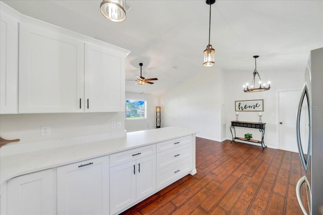 6142 SE 37th Ter, Ocala, FL 34480 - kitchen with freestanding refrigerator, white cabinetry, dark wood-style flooring, a ceiling fan, and hanging light fixtures