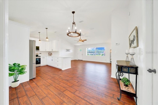 6142 SE 37th Ter, Ocala, FL 34480 - unfurnished living room featuring dark wood-type flooring, a chandelier, vaulted ceiling, and a ceiling fan