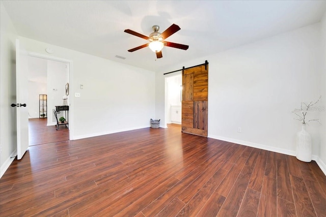 6142 SE 37th Ter, Ocala, FL 34480 - empty room featuring ceiling fan, a barn door, wood finished floors, and a smoke detector