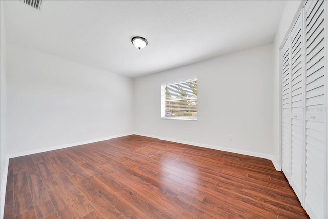 6142 SE 37th Ter, Ocala, FL 34480 - unfurnished bedroom with dark wood-style floors and a closet