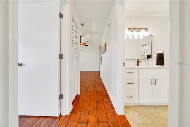 6142 SE 37th Ter, Ocala, FL 34480 - hallway with wood finished floors and a sink