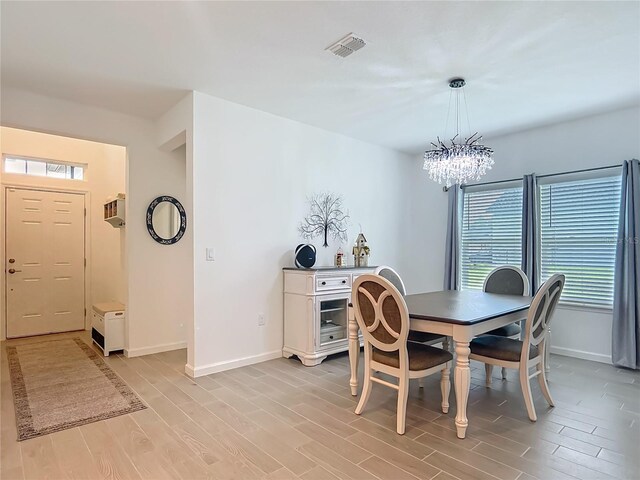 19424 SW 77th Loop, Dunnellon, FL 34432 - dining space featuring light wood-style flooring and a chandelier