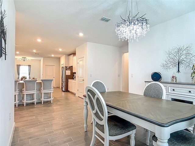 19424 SW 77th Loop, Dunnellon, FL 34432 - dining area with light wood-style floors, a chandelier, and recessed lighting