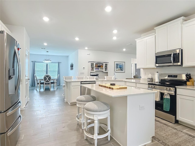 19424 SW 77th Loop, Dunnellon, FL 34432 - kitchen with stainless steel appliances, a peninsula, light countertops, a center island, and recessed lighting