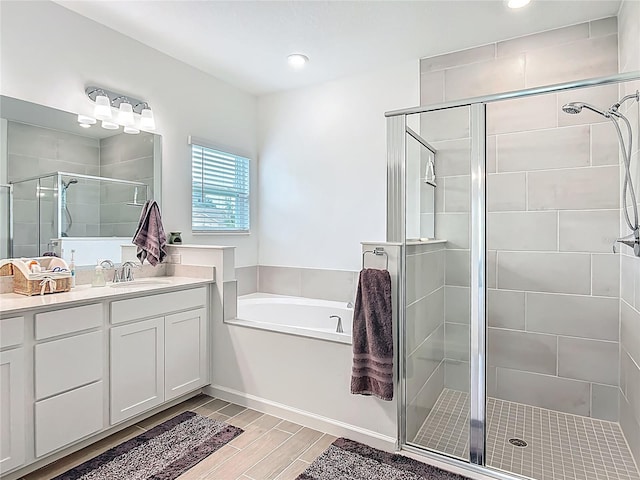 19424 SW 77th Loop, Dunnellon, FL 34432 - bathroom with a stall shower, a garden tub, vanity, wood tiled floors, and recessed lighting
