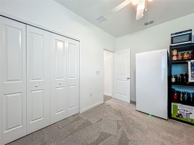 19424 SW 77th Loop, Dunnellon, FL 34432 - unfurnished bedroom with freestanding refrigerator, a closet, carpet floors, and ceiling fan
