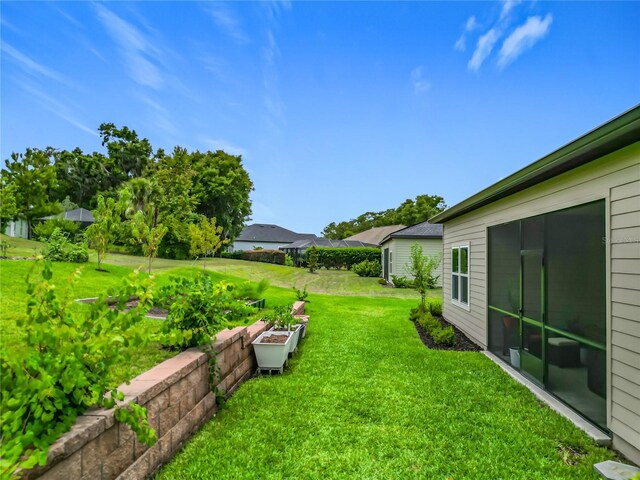 19424 SW 77th Loop, Dunnellon, FL 34432 - view of green lawn featuring a garden