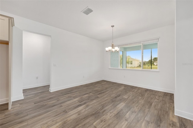 10561 SW 98th Pl, Ocala, FL 34481 - unfurnished room featuring wood finished floors and a chandelier