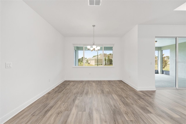 10561 SW 98th Pl, Ocala, FL 34481 - spare room with a chandelier, plenty of natural light, and wood finished floors