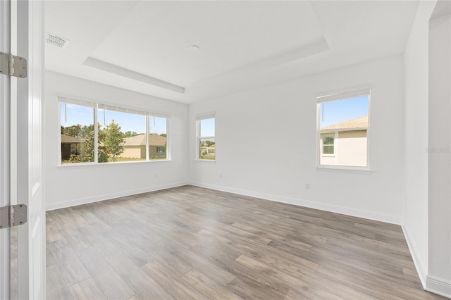 10561 SW 98th Pl, Ocala, FL 34481 - empty room featuring a tray ceiling and wood finished floors