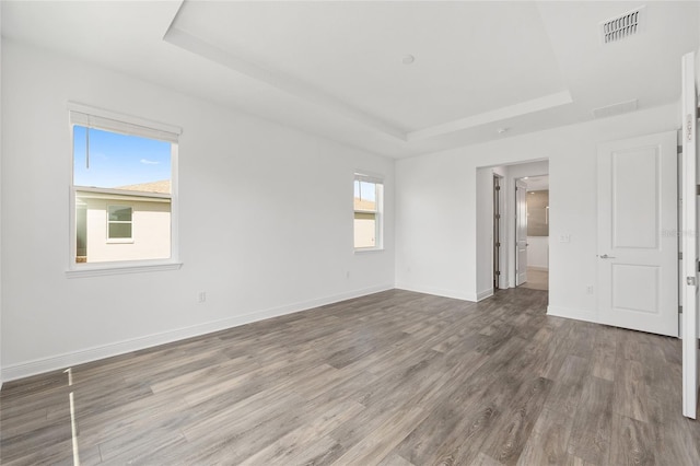10561 SW 98th Pl, Ocala, FL 34481 - empty room with a raised ceiling and wood finished floors