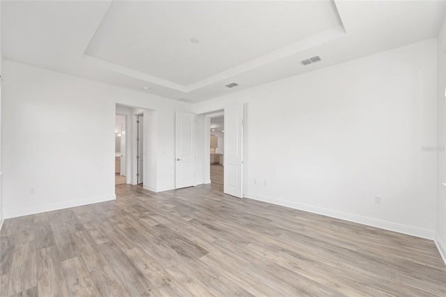 10561 SW 98th Pl, Ocala, FL 34481 - unfurnished room with a raised ceiling and light wood finished floors