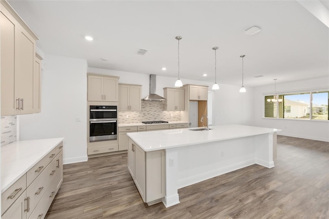 10561 SW 98th Pl, Ocala, FL 34481 - kitchen featuring wall chimney exhaust hood, stainless steel double oven, decorative backsplash, wood finished floors, and recessed lighting