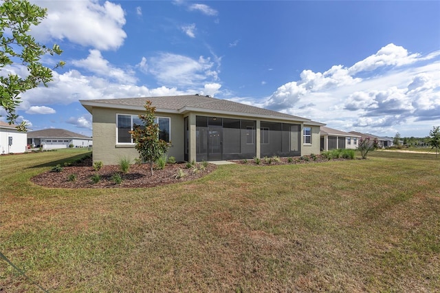 10561 SW 98th Pl, Ocala, FL 34481 - back of house with a sunroom, a lawn, and stucco siding