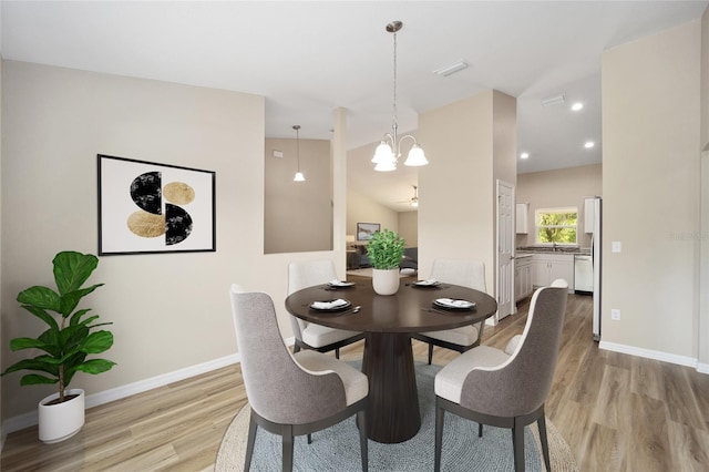 3870 W Fountain Ln, Citrus Springs, FL 34433 - dining area with light wood-style floors, a chandelier, and recessed lighting