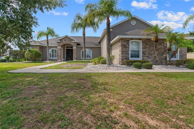 4731 SE 34th St, Ocala, FL 34480 - ranch-style house featuring stone siding, a front yard, and stucco siding