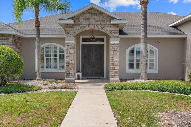 4731 SE 34th St, Ocala, FL 34480 - entrance to property featuring stone siding, stucco siding, roof with shingles, and a yard