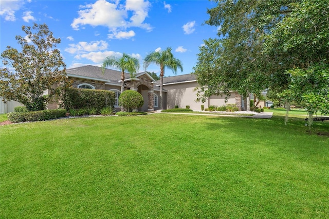 4731 SE 34th St, Ocala, FL 34480 - view of front of property featuring stone siding, a front lawn, and stucco siding