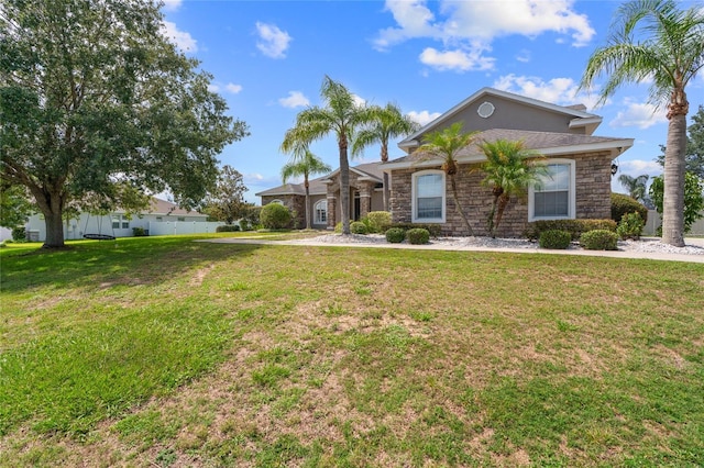4731 SE 34th St, Ocala, FL 34480 - view of front facade featuring stone siding and a front yard