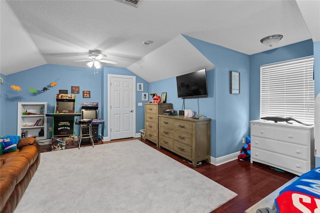 4731 SE 34th St, Ocala, FL 34480 - bedroom with dark wood finished floors, vaulted ceiling, a ceiling fan, and a textured ceiling