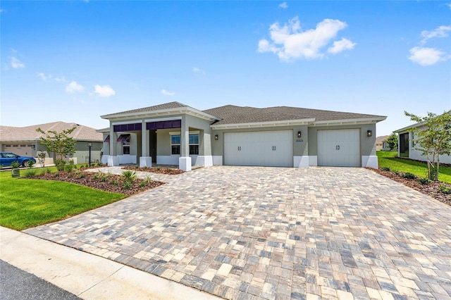 10026 SW 85th Place Rd, Ocala, FL 34481 - view of front of home featuring stucco siding, decorative driveway, a garage, and a front yard