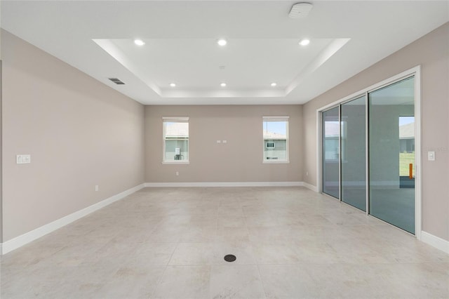 10026 SW 85th Place Rd, Ocala, FL 34481 - unfurnished room featuring a raised ceiling, recessed lighting, and light tile patterned floors