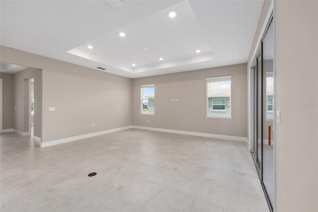 10026 SW 85th Place Rd, Ocala, FL 34481 - unfurnished room featuring a tray ceiling, recessed lighting, and light tile patterned flooring